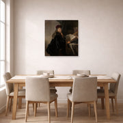Unframed poster print of Rembrandt's A Scholar Seated at a Desk displayed on a wall in a dining room