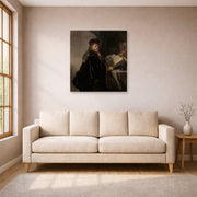 Unframed poster print of Rembrandt's A Scholar Seated at a Desk displayed on a wall in a living room