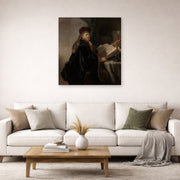 Unframed poster print of Rembrandt's A Scholar Seated at a Desk displayed on a wall in a living room