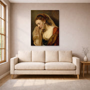 Gallery-wrapped canvas print of Rembrandt's A Weeping Woman displayed on a wall in a living room