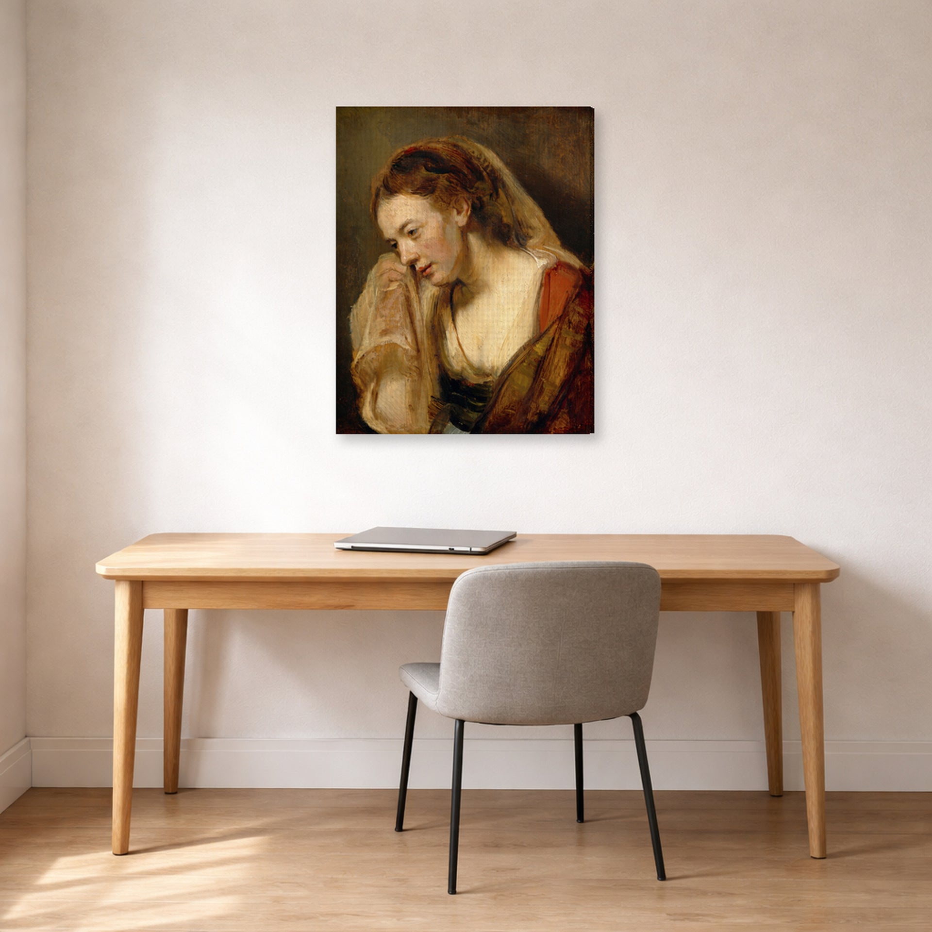 Gallery-wrapped canvas print of Rembrandt's A Weeping Woman displayed on a wall in an office