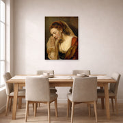 Unframed poster print of Rembrandt's A Weeping Woman displayed on a wall in a dining room