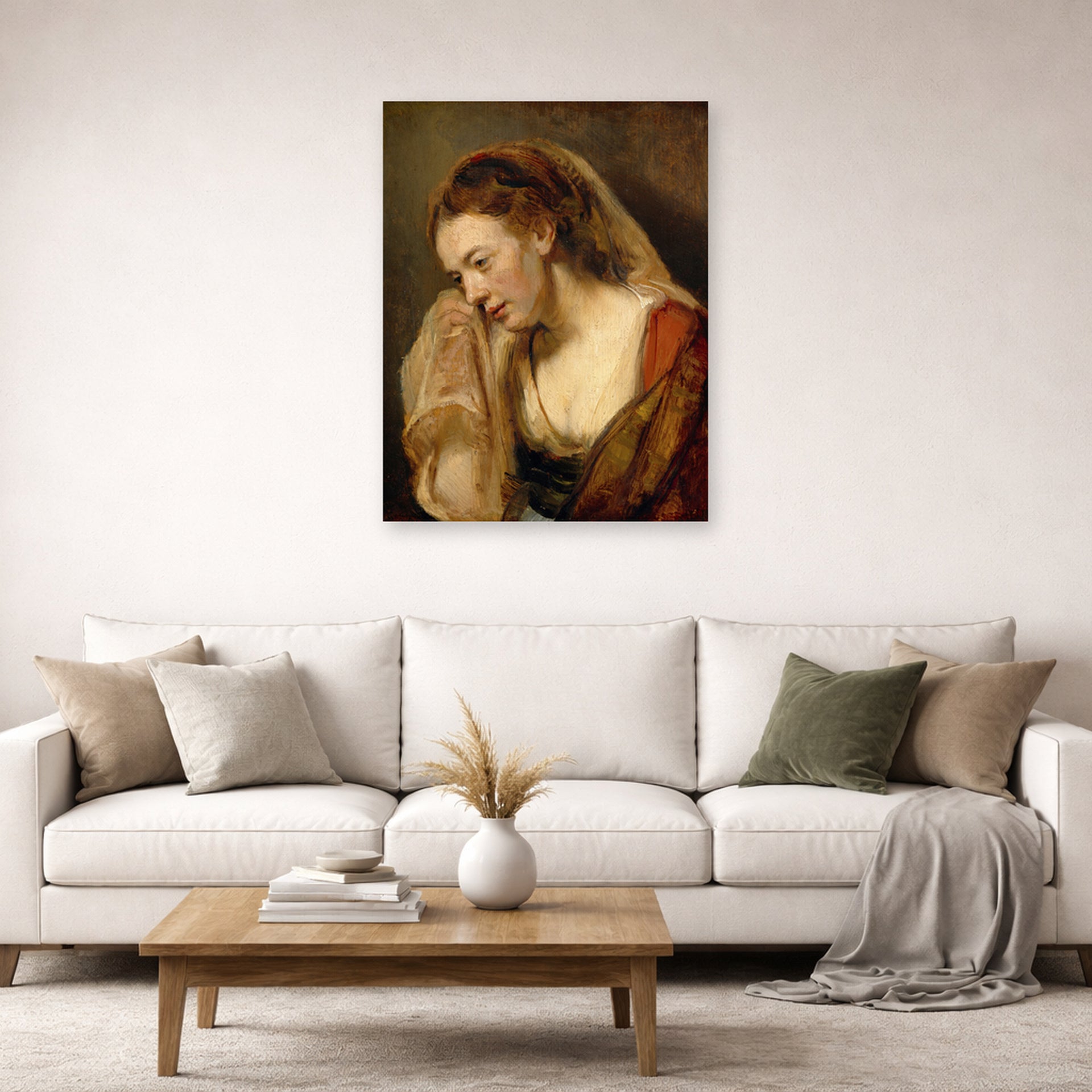 Unframed poster print of Rembrandt's A Weeping Woman displayed on a wall in a living room