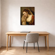 Unframed poster print of Rembrandt's A Weeping Woman displayed on a wall in an office