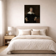 Gallery-wrapped canvas print of Rembrandt's A Woman Holding a Pink displayed on a wall in a bedroom