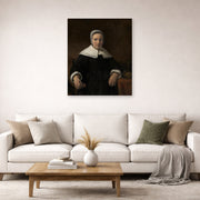 Unframed poster print of Rembrandt's A Woman Holding a Pink displayed on a wall in a living room