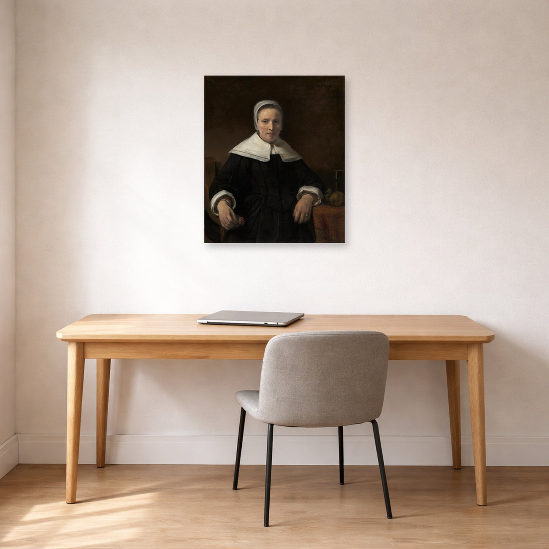 Unframed poster print of Rembrandt's A Woman Holding a Pink displayed on a wall in an office