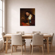 Unframed poster print of Rembrandt's An Old Woman Weighing Gold Coins displayed on a wall in a dining room