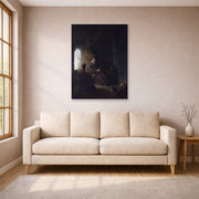 Unframed poster print of Rembrandt's Anna and the Blind Tobit displayed on a wall in a living room