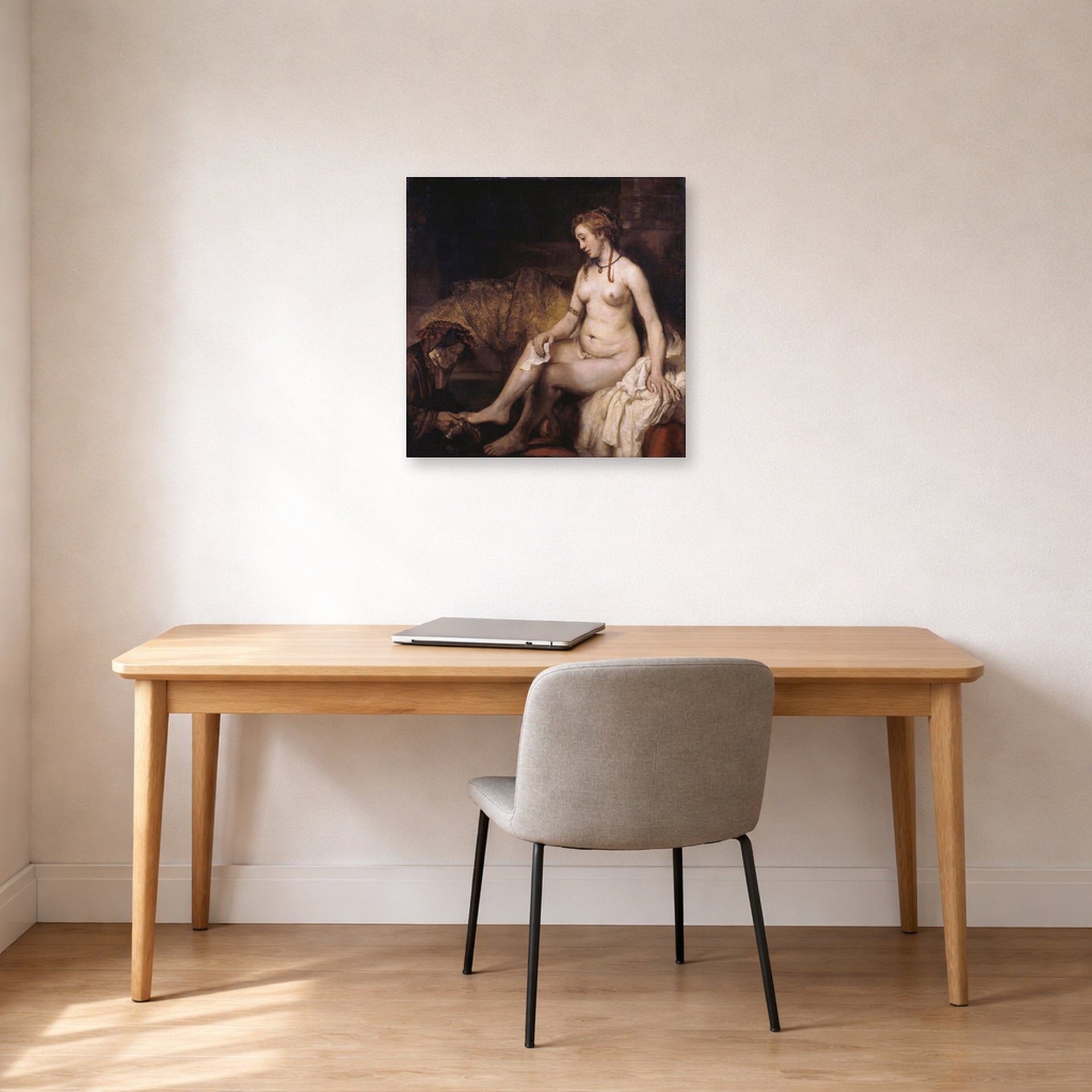 Unframed poster print of Rembrandt's Bathsheba at Her Bath displayed on a wall in an office