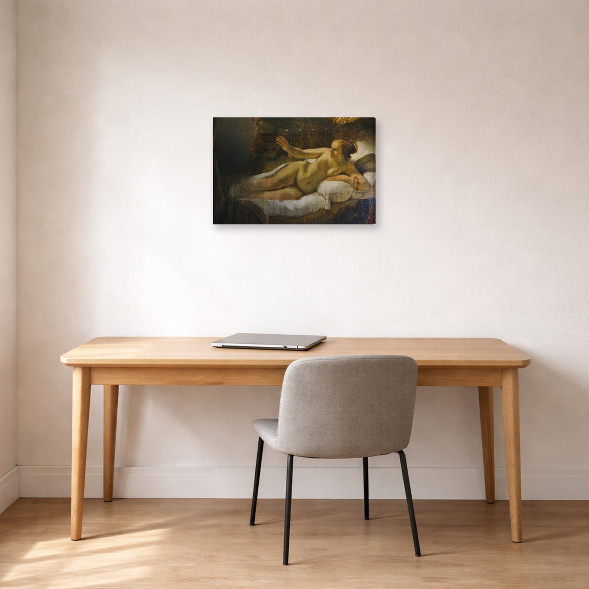 Gallery-wrapped canvas print of Rembrandt's Danaë displayed on a wall in an office