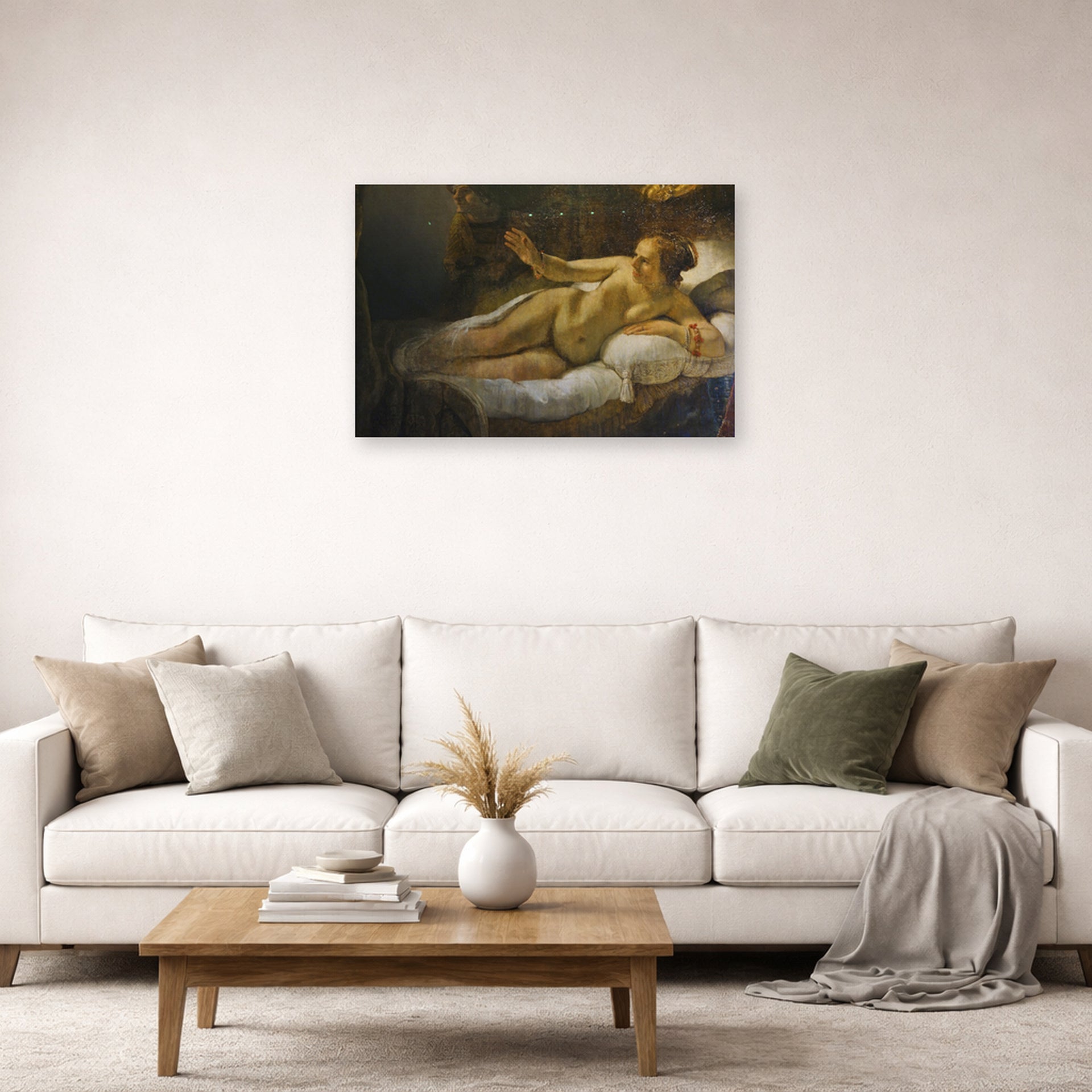 Unframed poster print of Rembrandt's Danaë displayed on a wall in a living room
