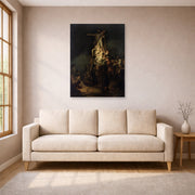 Unframed poster print of Rembrandt's Descent from the Cross displayed on a wall in a living room