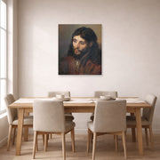 Unframed poster print of Rembrandt's Head of Christ displayed on a wall in a dining room