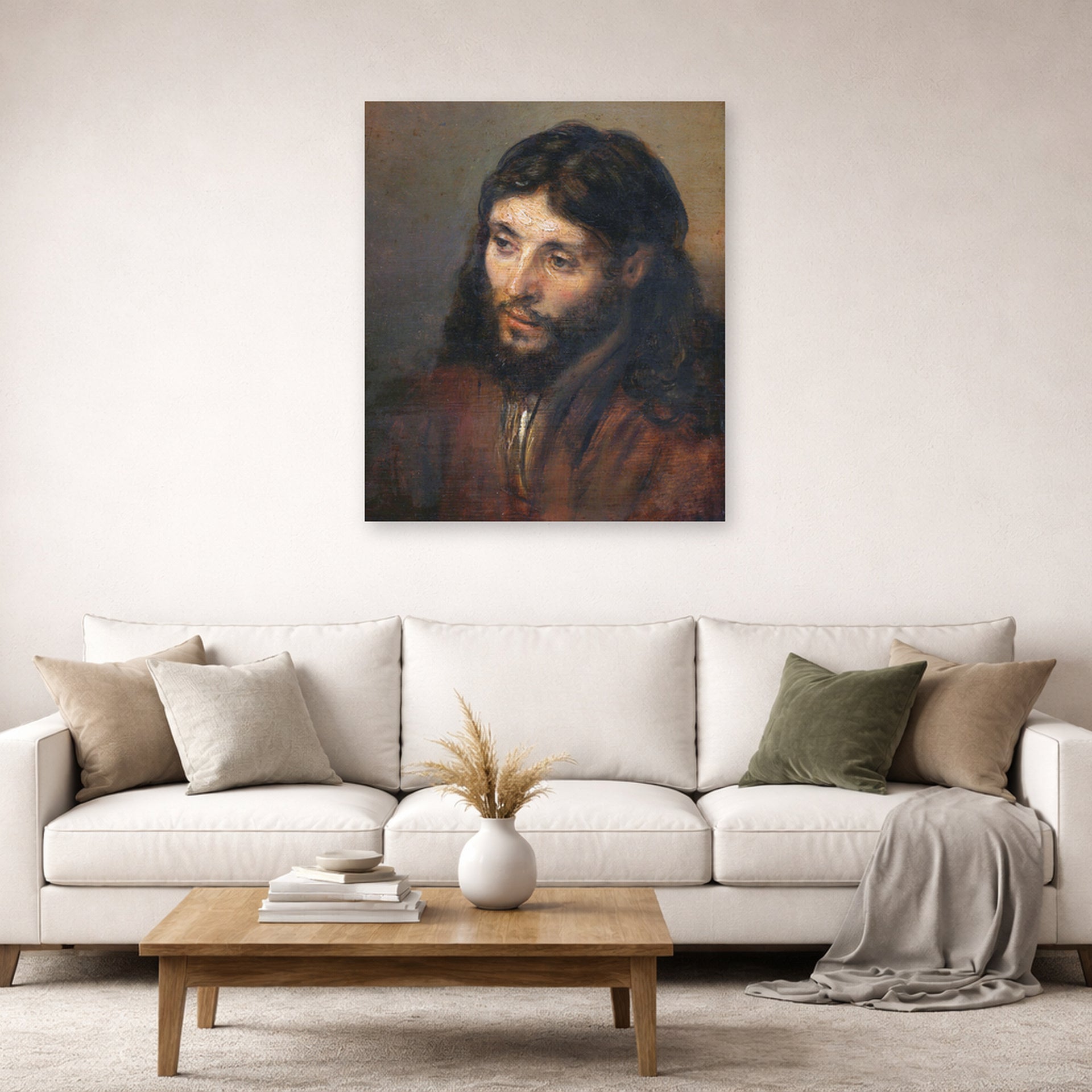 Unframed poster print of Rembrandt's Head of Christ displayed on a wall in a living room