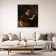 Gallery-wrapped canvas print of Rembrandt's Holy Family displayed on a wall in a living room