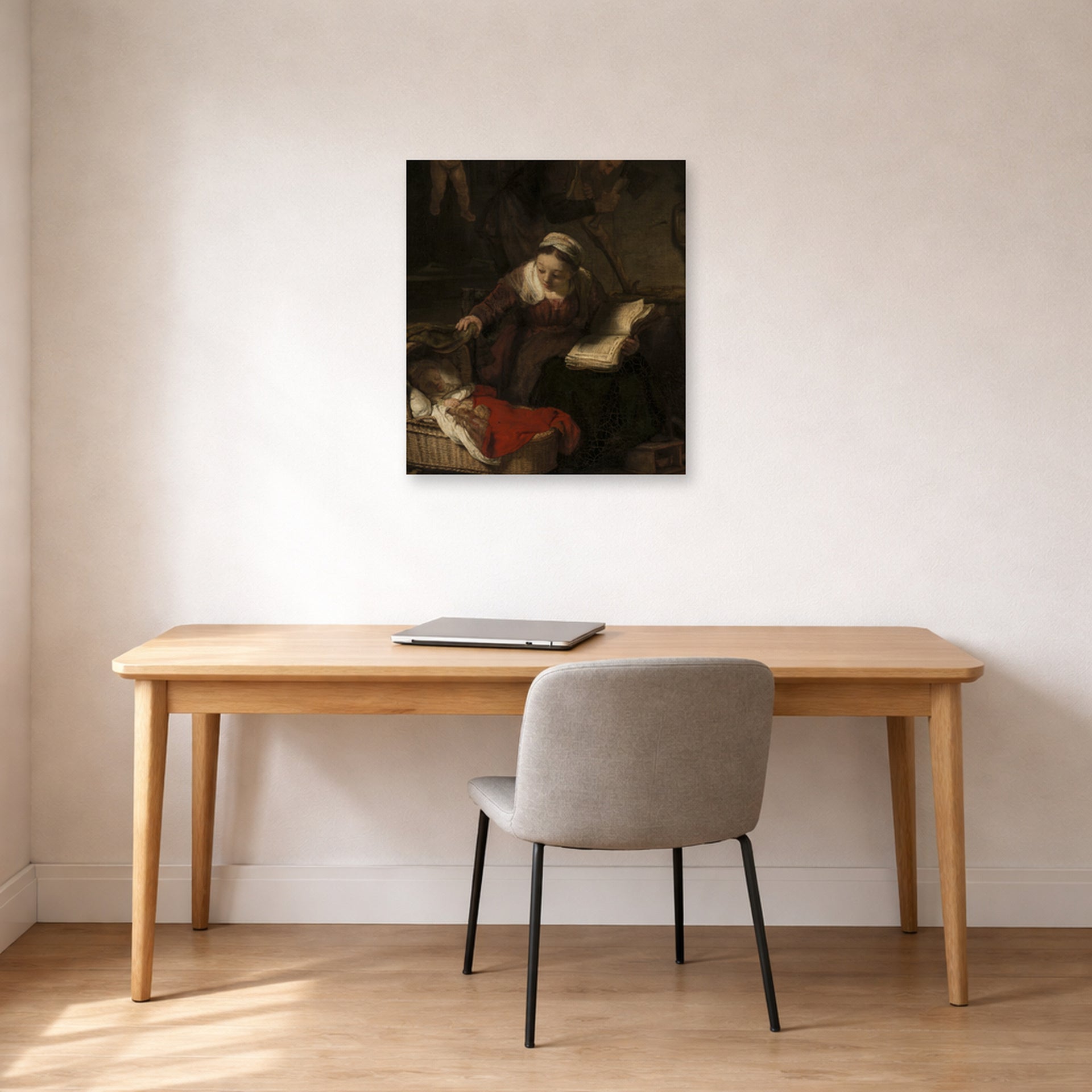 Unframed poster print of Rembrandt's Holy Family displayed on a wall in an office