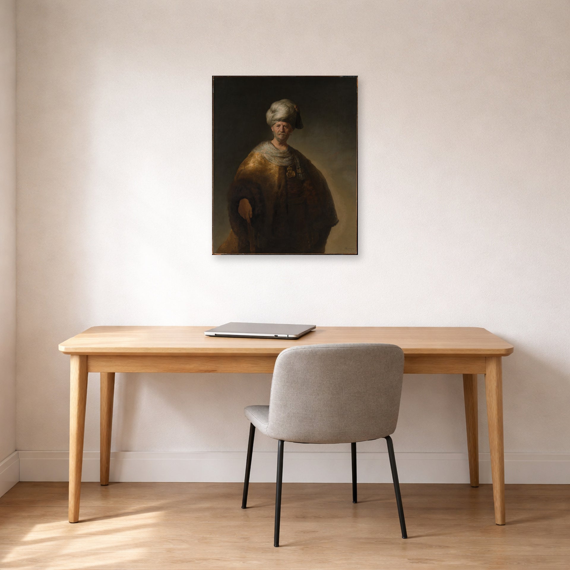 Unframed poster print of Rembrandt's Man in Oriental Costume displayed on a wall in an office