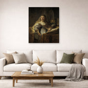 Gallery-wrapped canvas print of Rembrandt's Minerva in Her Study displayed on a wall in a living room