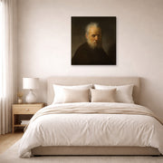 Gallery-wrapped canvas print of Rembrandt's Old Man with Beard displayed on a wall in a bedroom