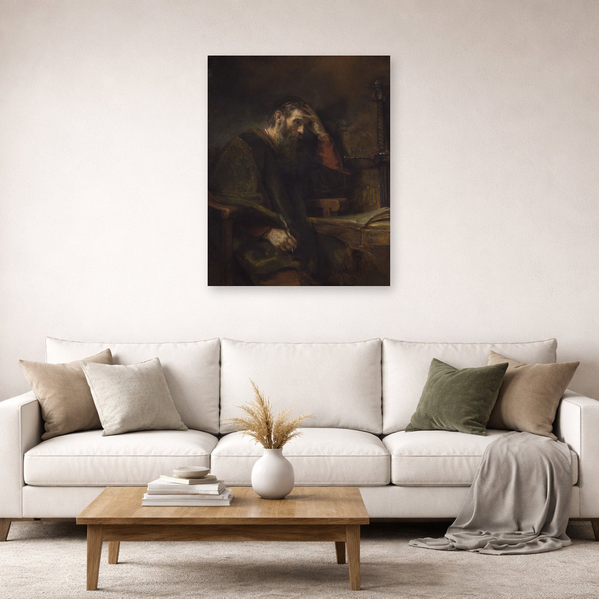 Unframed poster print of Rembrandt's Paul the Apostle displayed on a wall in a living room