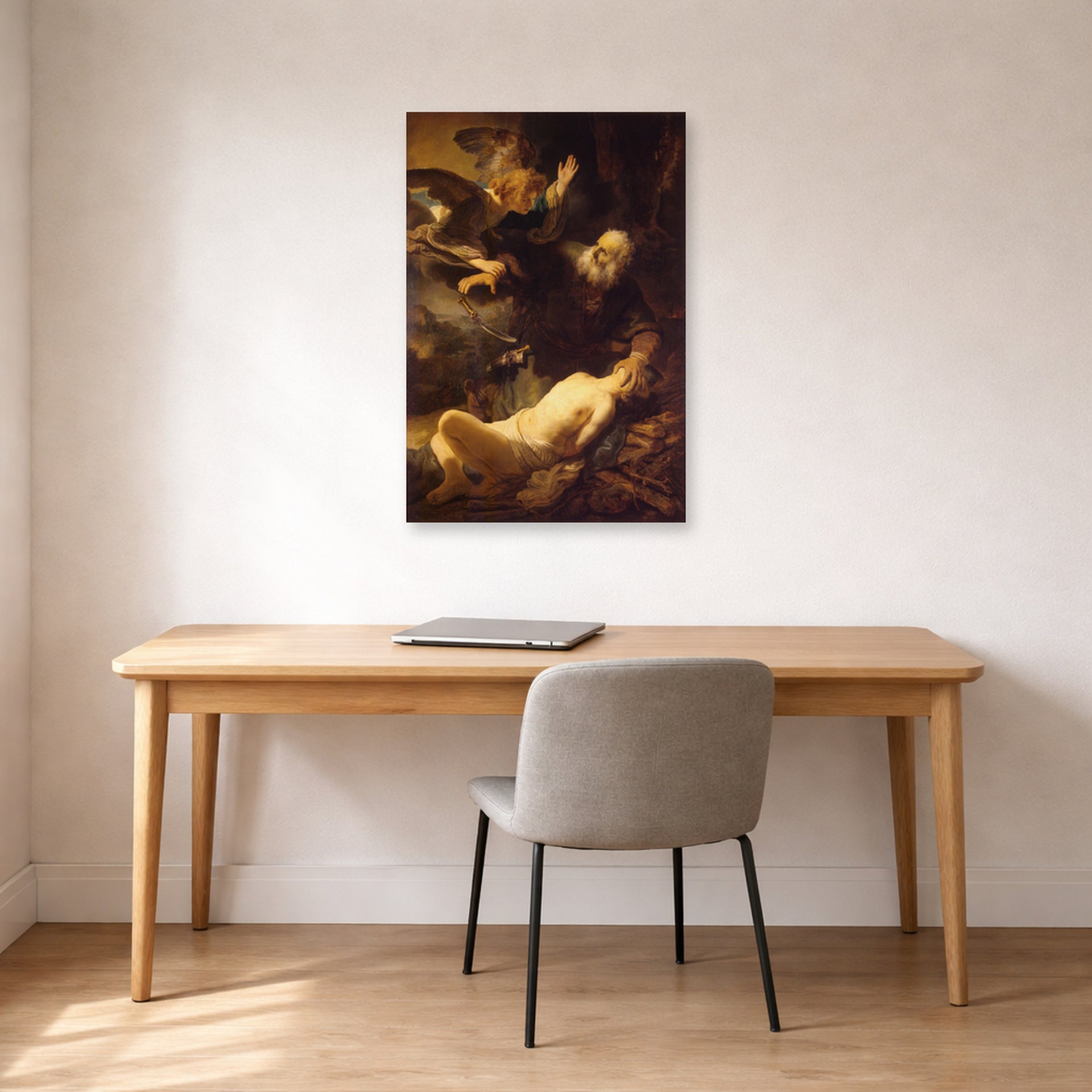 Unframed poster print of Rembrandt's Sacrifice of Isaac displayed on a wall in an office