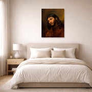Unframed poster print of Rembrandt's Study for the Head of Young Man displayed on a wall in a bedroom