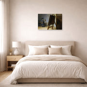 Gallery-wrapped canvas print of Rembrandt's The Artist in his Studio displayed on a wall in a bedroom