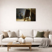 Gallery-wrapped canvas print of Rembrandt's The Artist in his Studio displayed on a wall in a living room