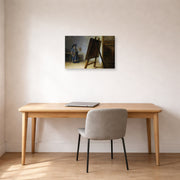 Gallery-wrapped canvas print of Rembrandt's The Artist in his Studio displayed on a wall in an office