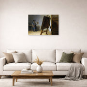 Unframed poster print of Rembrandt's The Artist in his Studio displayed on a wall in a living room