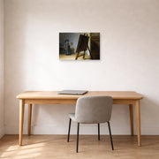 Unframed poster print of Rembrandt's The Artist in his Studio displayed on a wall in an office