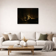 Gallery-wrapped canvas print of Rembrandt's The Holy Family by Night displayed on a wall in a living room