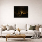Unframed poster print of Rembrandt's The Holy Family by Night displayed on a wall in a living room