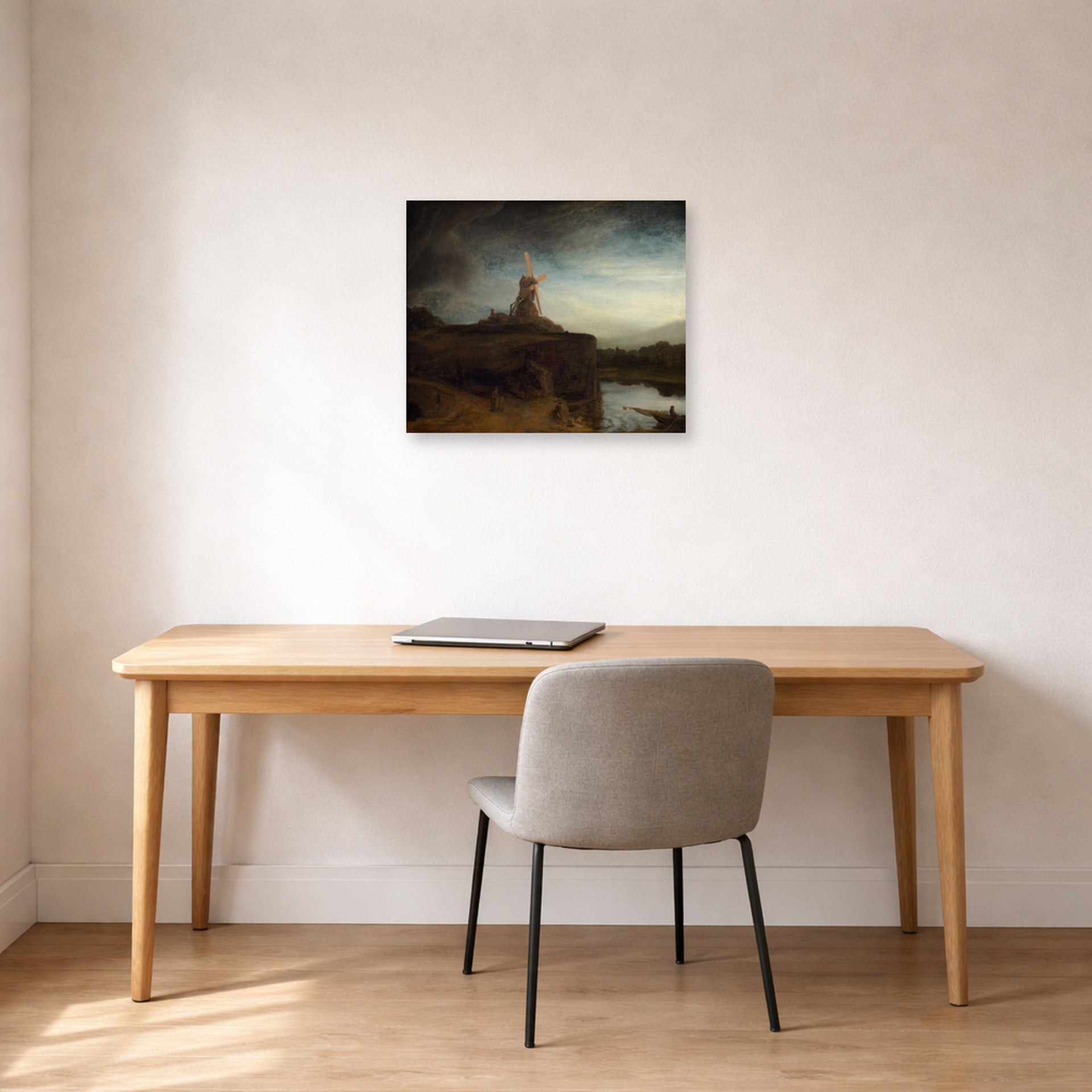 Unframed poster print of Rembrandt's The Mill displayed in a home office