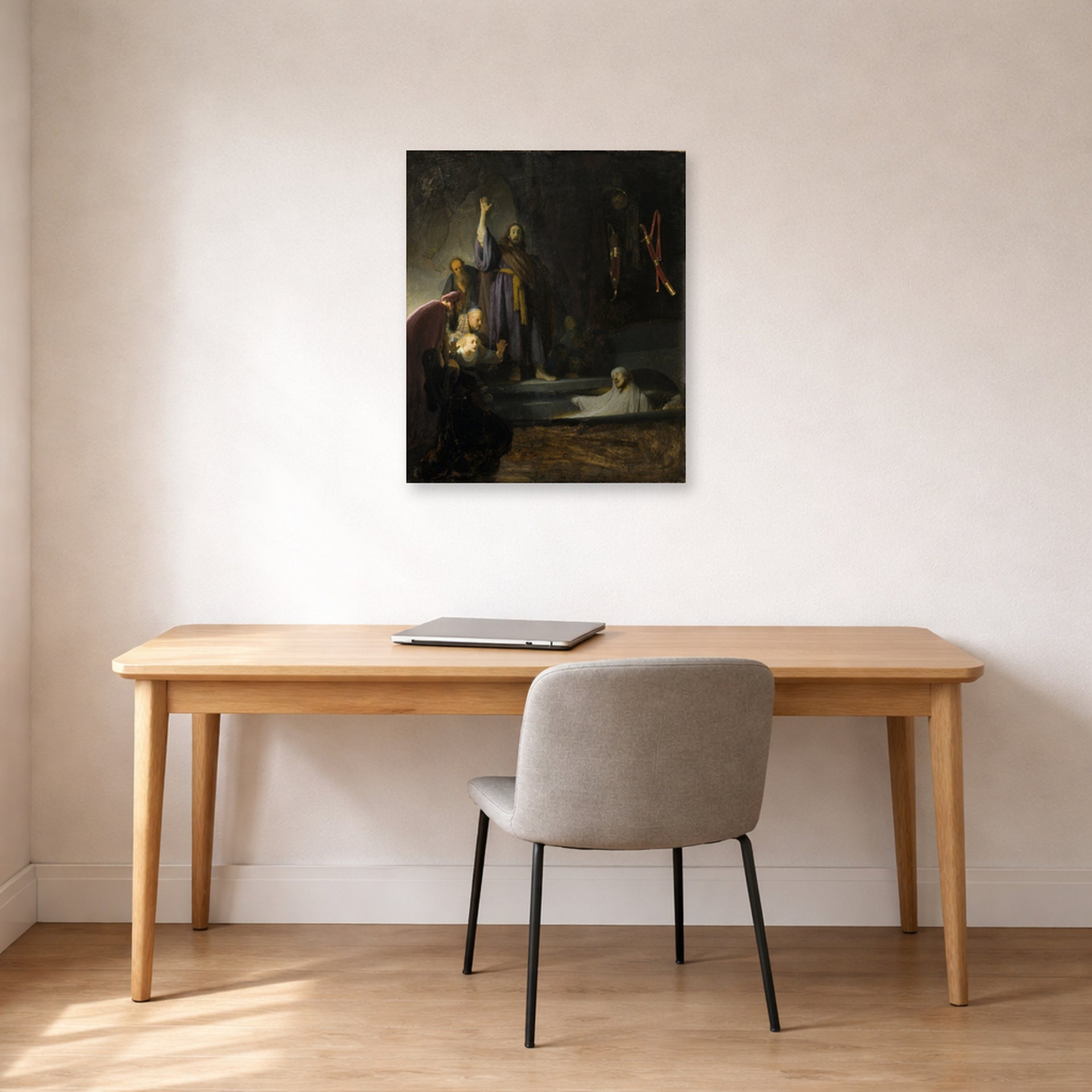 Unframed poster print of Rembrandt's The Raising of Lazarus displayed on a wall in an office