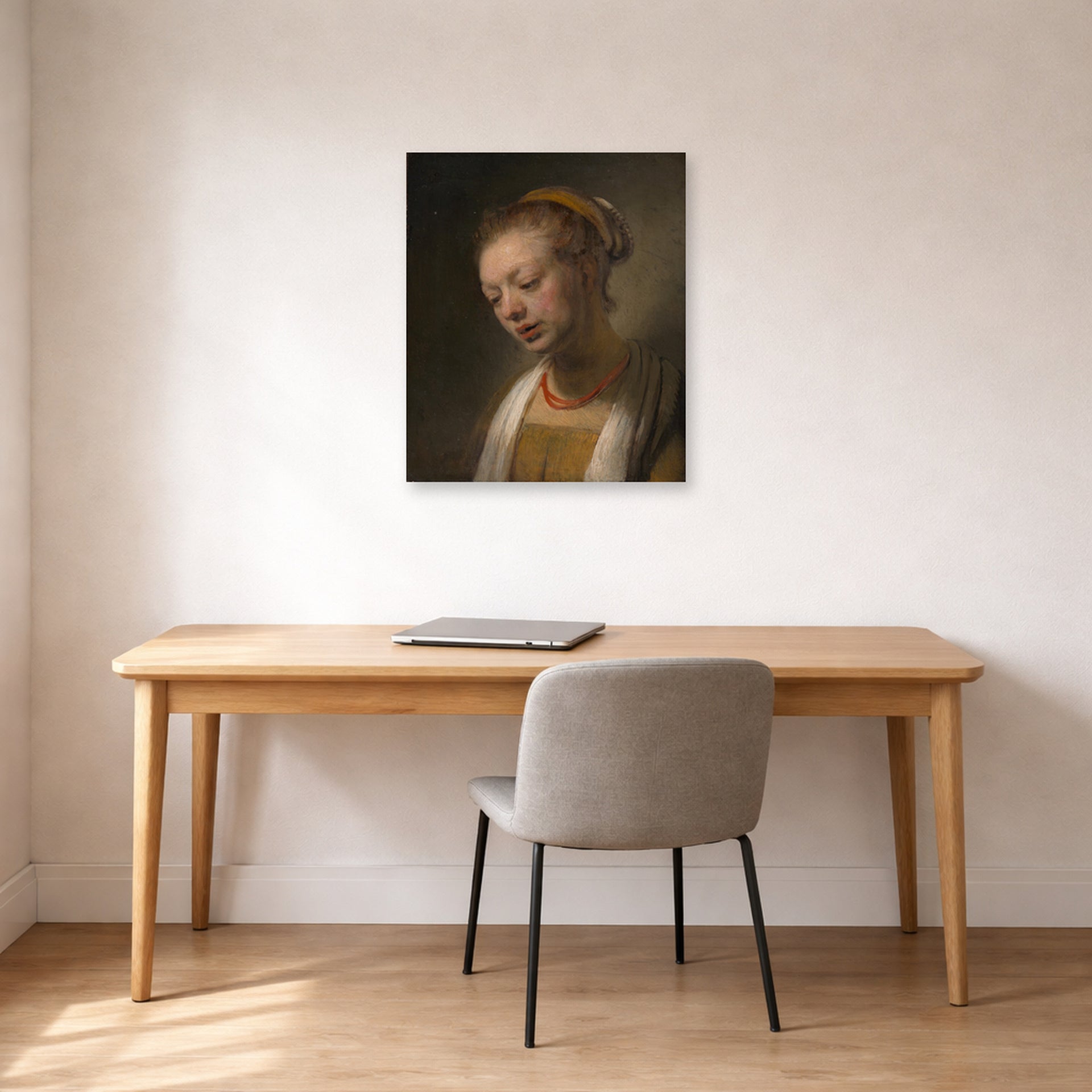 Unframed poster print of Rembrandt's Young Woman with a Red Necklace displayed on a wall in an office