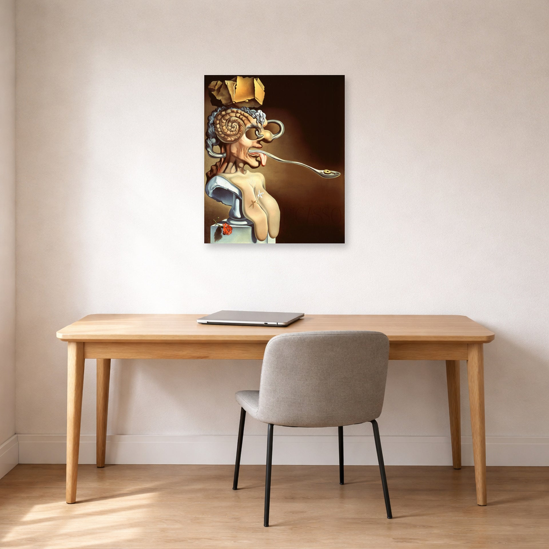 Unframed poster print of Salvador Dali's Portrait of Picasso displayed on a wall in a office