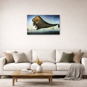 Gallery-wrapped canvas print of Salvador Dali's Sleep displayed on a wall in a living room
