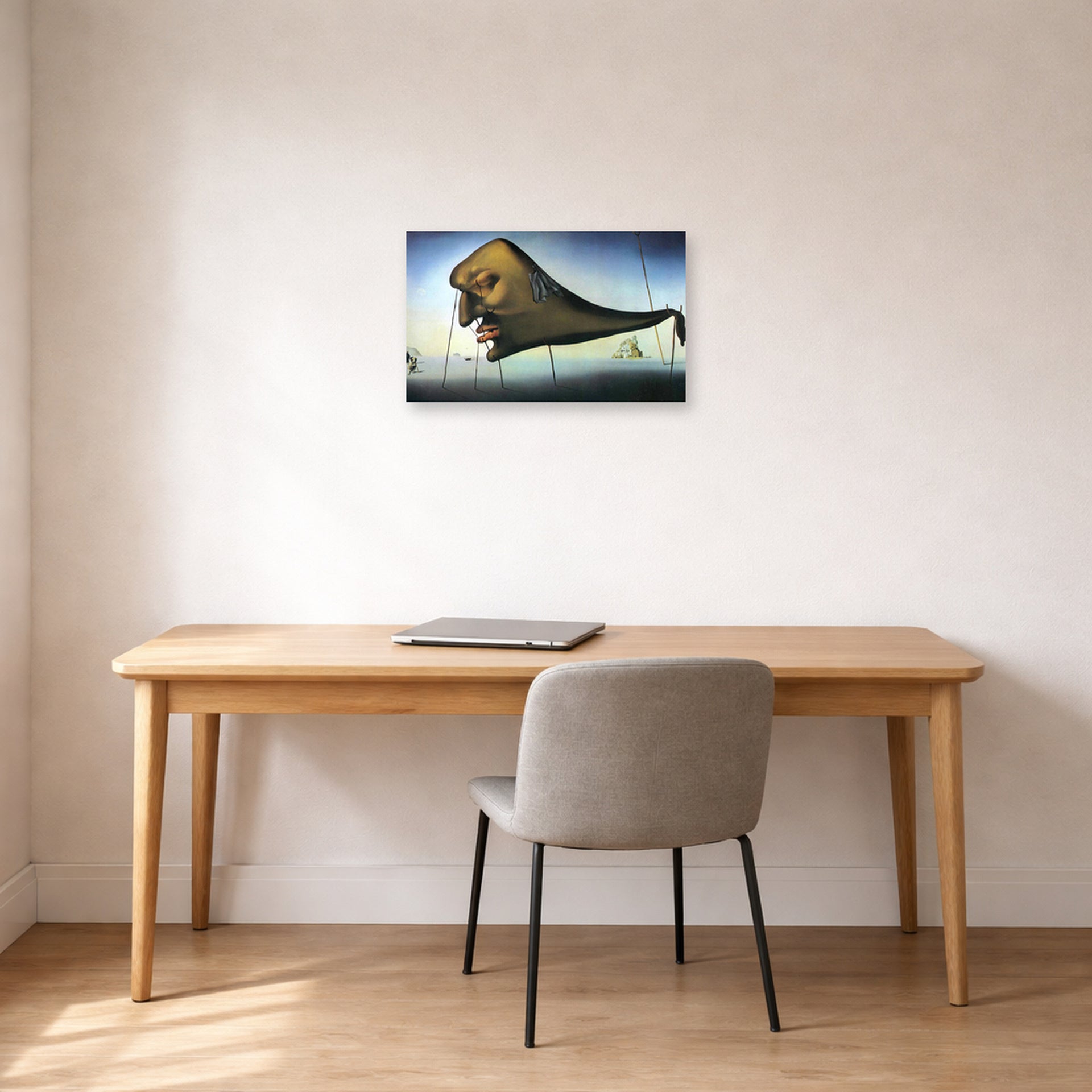 Unframed poster print of Salvador Dali's Sleep displayed on a wall in a office