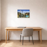 Unframed poster print of Salvador Dali's Swans Reflecting Elephants displayed on a wall in a office
