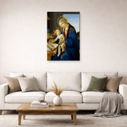 Unframed poster print of Sandro Botticelli's Madonna of the Book displayed on a wall in a living room