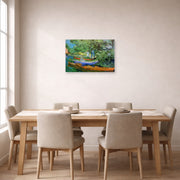 Unframed poster print of Vincent van Gogh's Bank of the Oise at Auvers displayed on a wall in a dining room