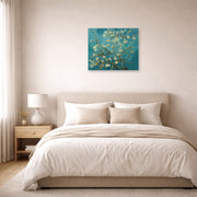 Unframed poster print of Vincent van Gogh's Blossoming Almond Tree displayed on a wall in a bedroom