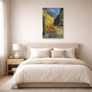 Gallery-wrapped canvas print of Vincent van Gogh's Cafe Terrace at Night displayed on a wall in a bedroom