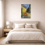 Unframed poster print of Vincent van Gogh's Cafe Terrace at Night displayed on a wall in a bedroom