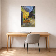 Unframed poster print of Vincent van Gogh's Cafe Terrace at Night displayed on a wall in a home office