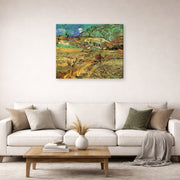 Gallery-wrapped canvas print of Vincent van Gogh's Enclosed Wheat Field with Peasant displayed on a wall in a living room