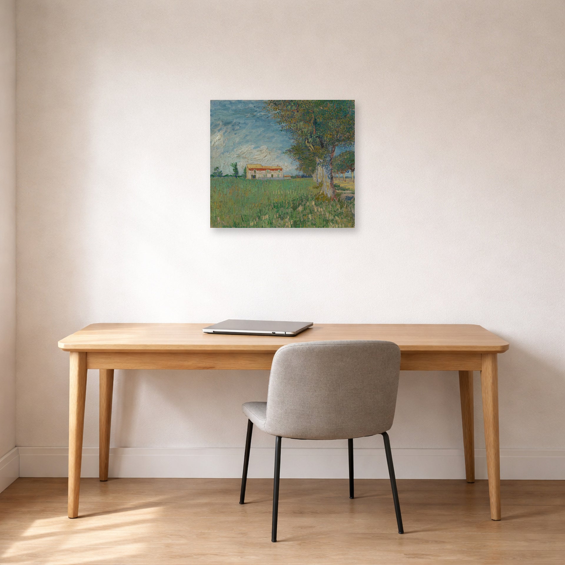 Unframed poster print of Vincent van Gogh's Farmhouse in a Wheatfield displayed on a wall in a home office