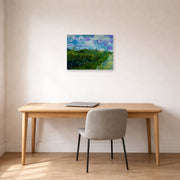Unframed poster print of Vincent van Gogh's Green Wheat Fields displayed on a wall in a home office